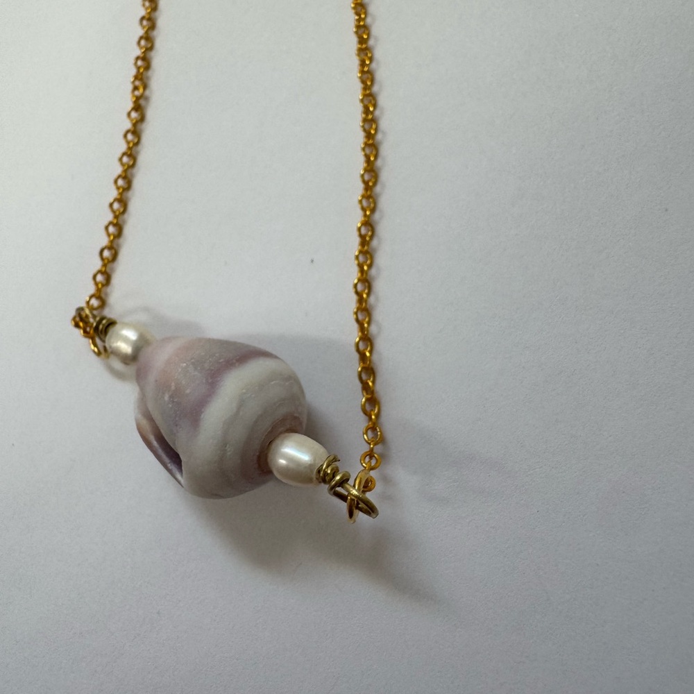 Handcrafted gold cone shell necklace with natural pearls